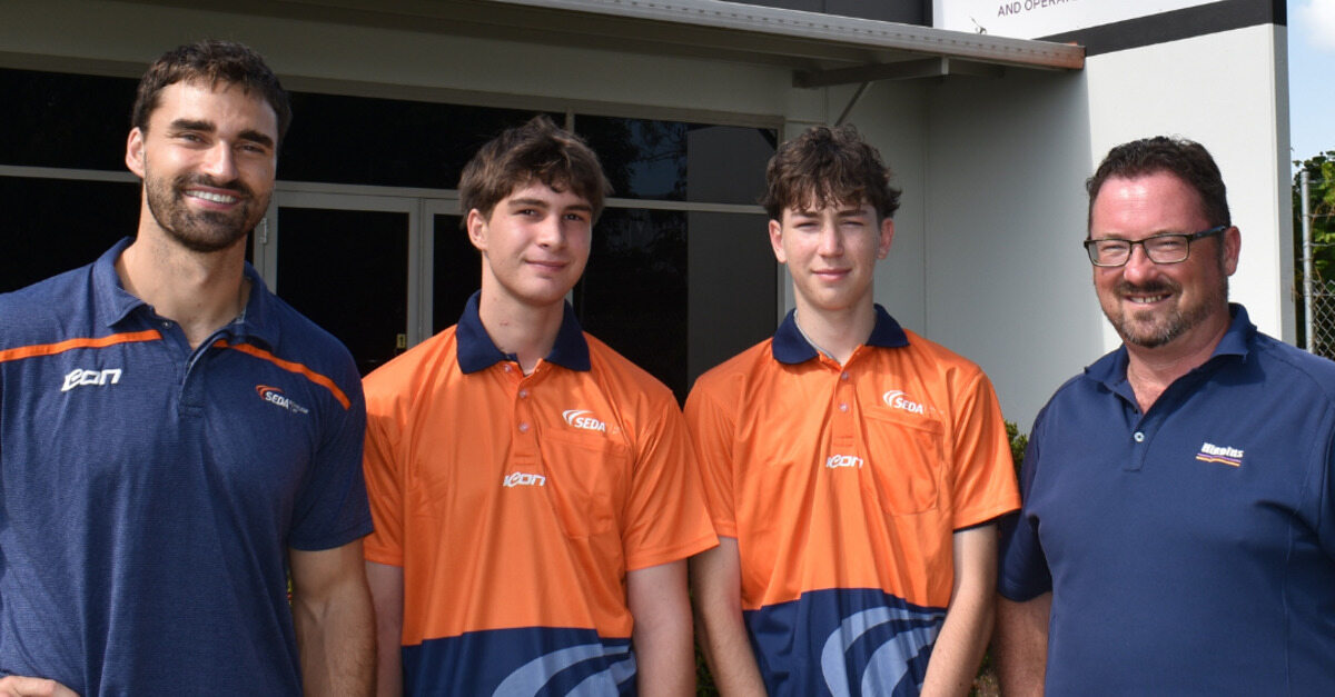 Higgins staff and SEDA College students pose outside the Higgins office.