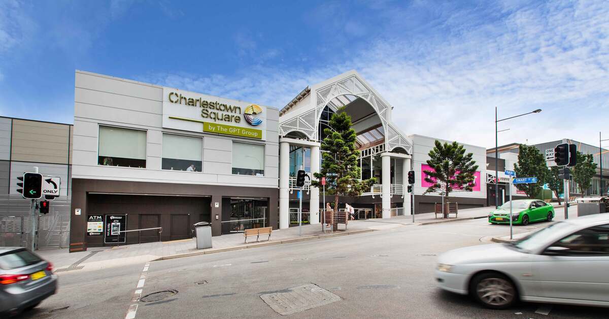 Street-level view of the Charlestown Square shopping centre entrance from a road intersection.